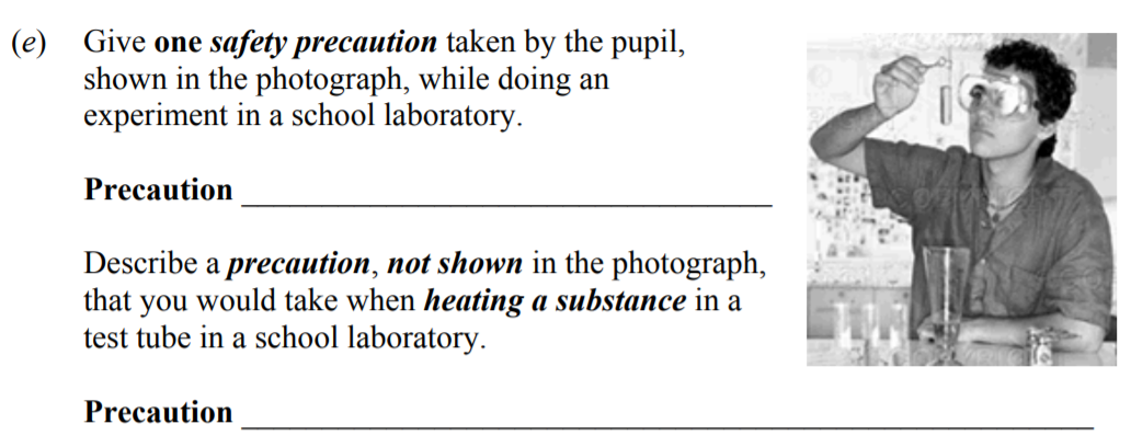 Give-one-safety-precaution-taken-by-the-pupil,-shown-in-the-photograph,-while-doing-an-experiment-in-a-school-laboratory-Junior Cycle Science-Question e-2008.png